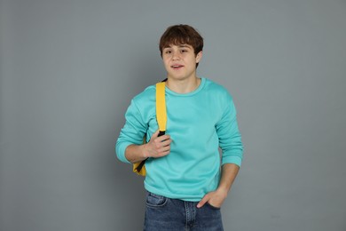 Photo of Portrait of teenage boy on grey background