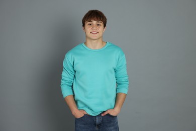 Photo of Portrait of teenage boy on grey background