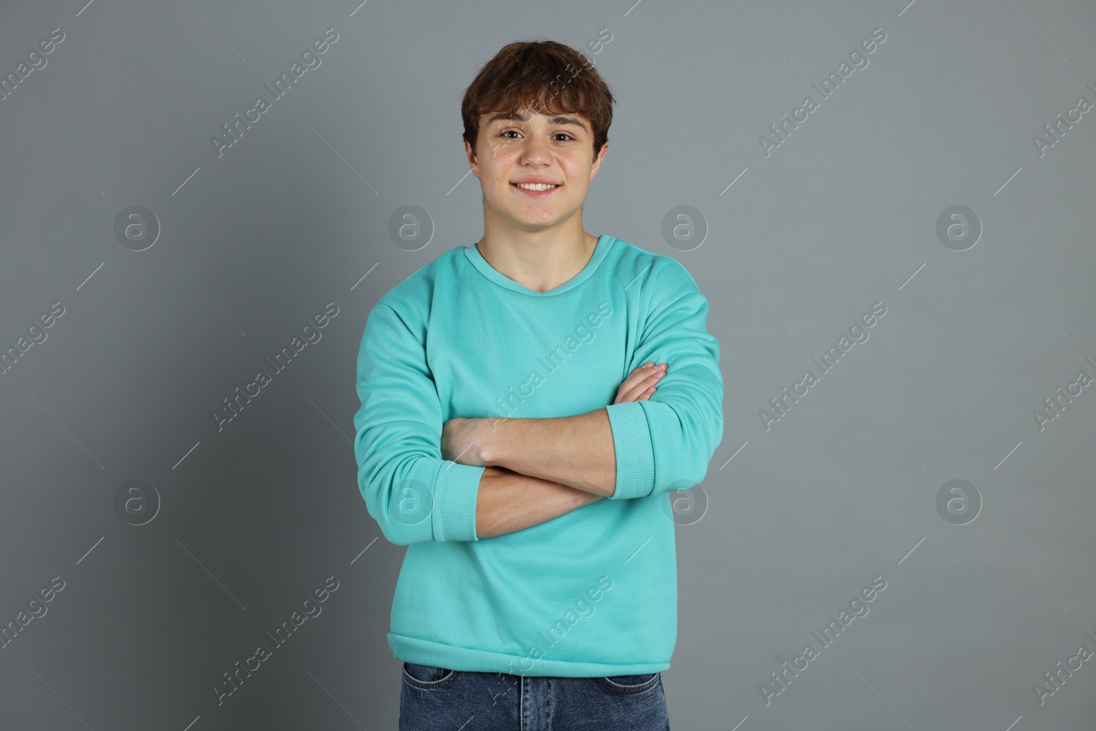 Portrait of teenage boy on grey background Photo of Portrait of teenage boy on grey background