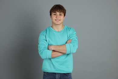 Photo of Portrait of teenage boy on grey background