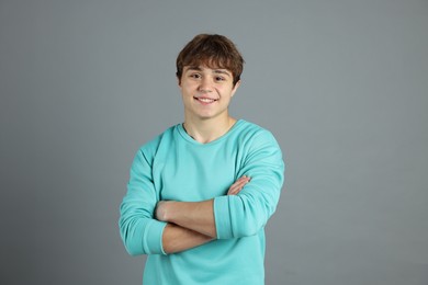 Photo of Portrait of teenage boy on grey background
