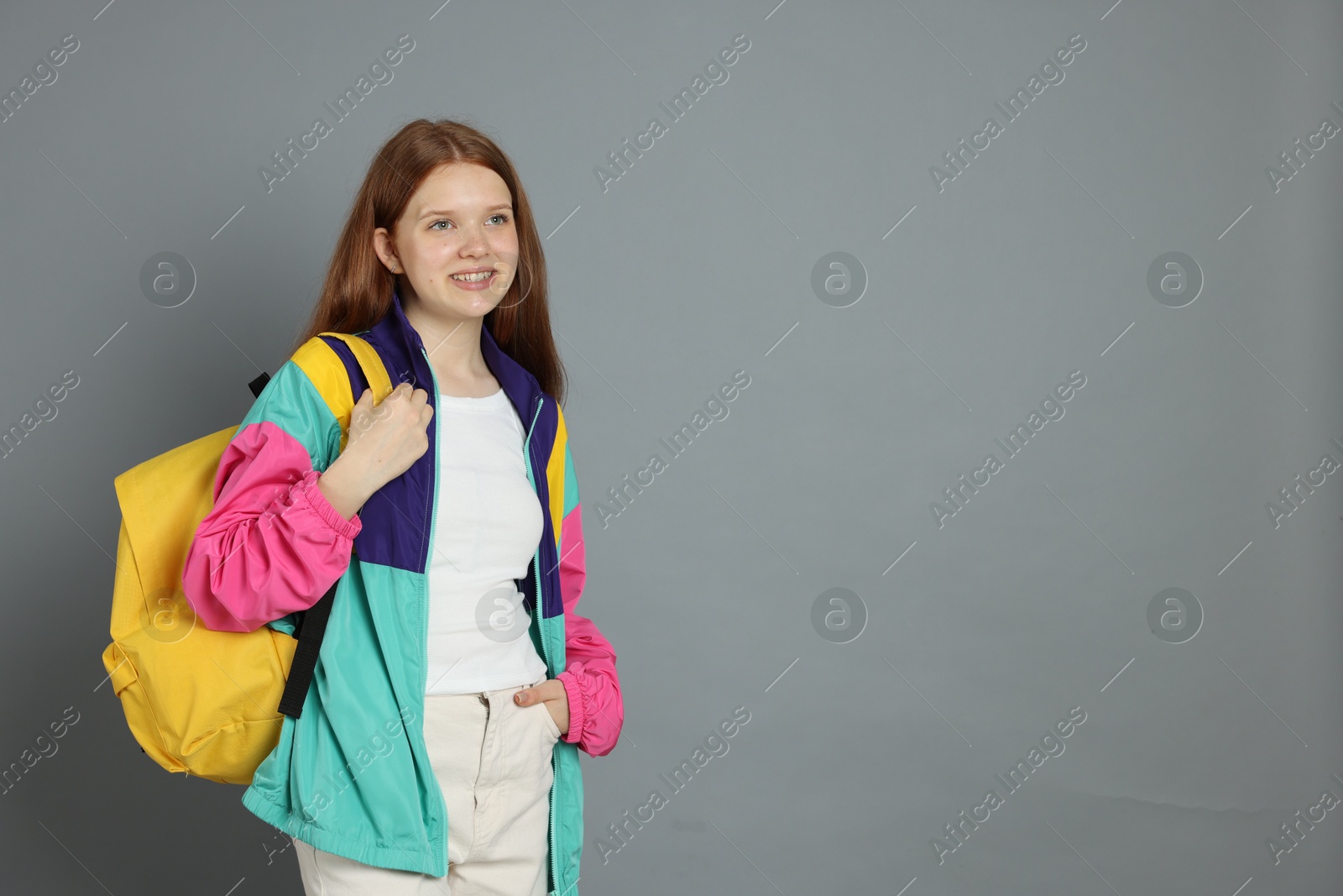 Portrait of teenage girl on grey background. Space for text Photo of Portrait of teenage girl on grey background. Space for text