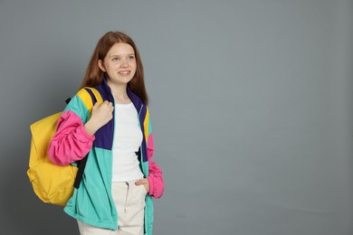 Photo of Portrait of teenage girl on grey background. Space for text
