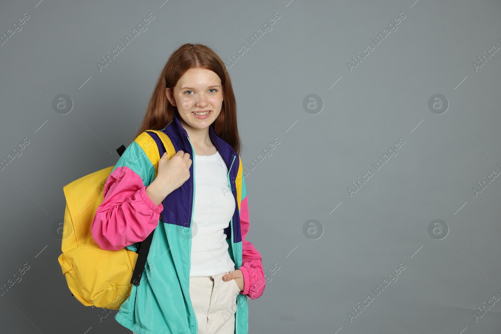 Portrait of teenage girl on grey background. Space for text Photo of Portrait of teenage girl on grey background. Space for text