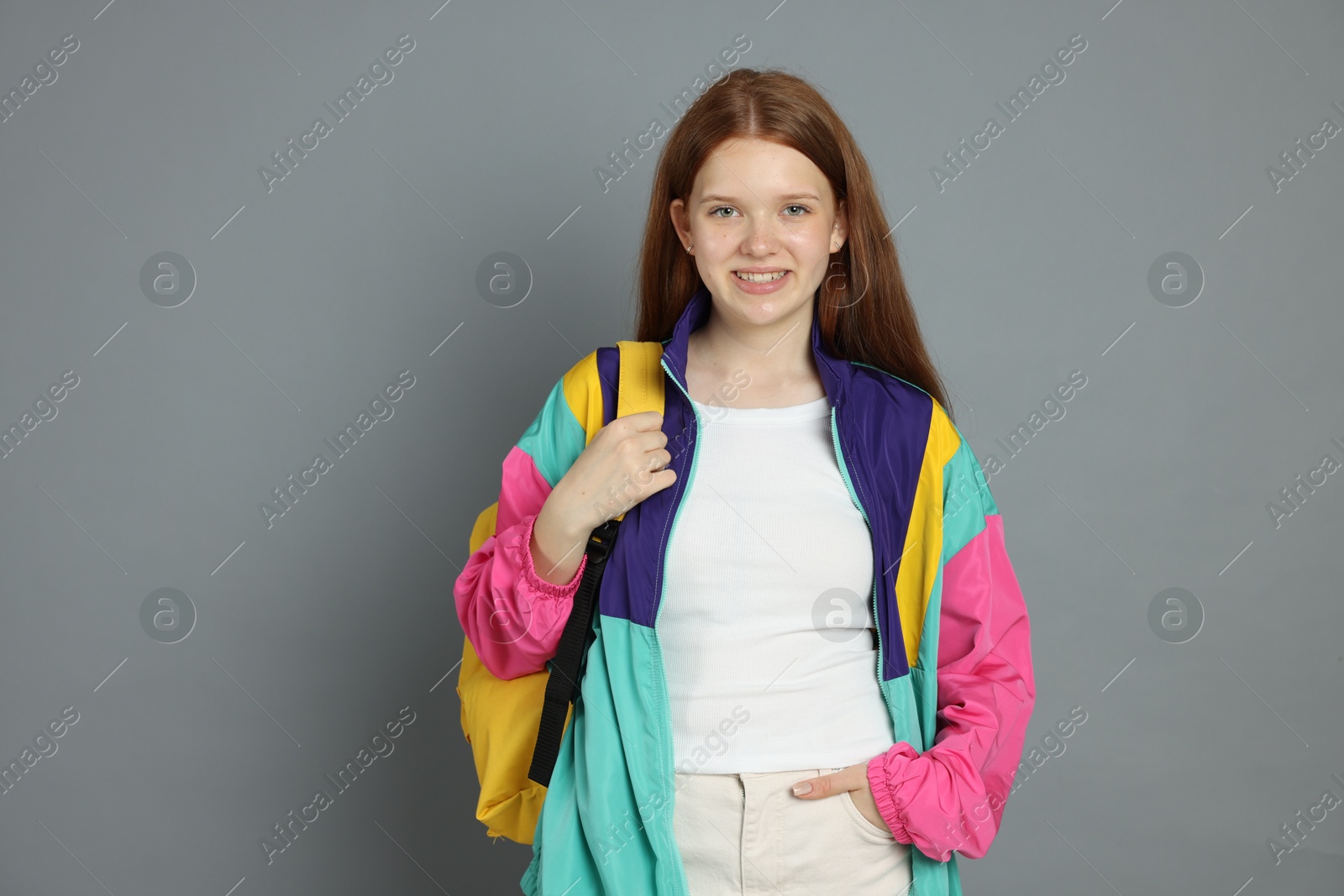 Portrait of teenage girl on grey background Photo of Portrait of teenage girl on grey background