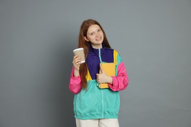 Photo of Teenage girl with drink on grey background