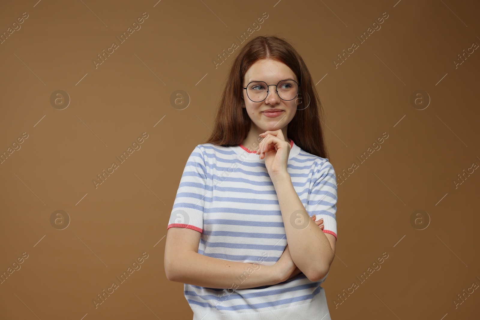 Portrait of teenage girl on brown background Photo of Portrait of teenage girl on brown background