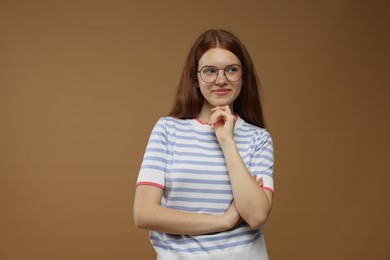 Photo of Portrait of teenage girl on brown background