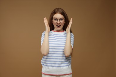 Photo of Portrait of emotional teenage girl on brown background