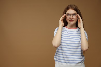 Photo of Portrait of teenage girl on brown background. Space for text