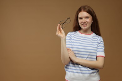 Photo of Portrait of teenage girl on brown background. Space for text