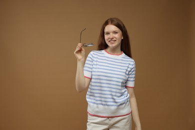 Photo of Portrait of teenage girl on brown background