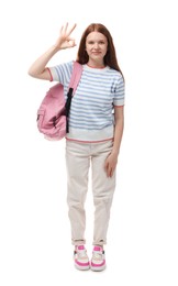 Photo of Teenage girl with backpack showing okay gesture on white background