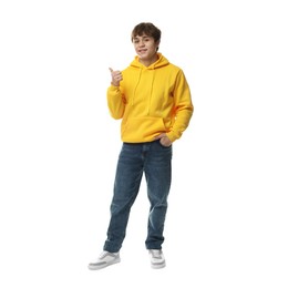 Photo of Teenage boy pointing at something on white background