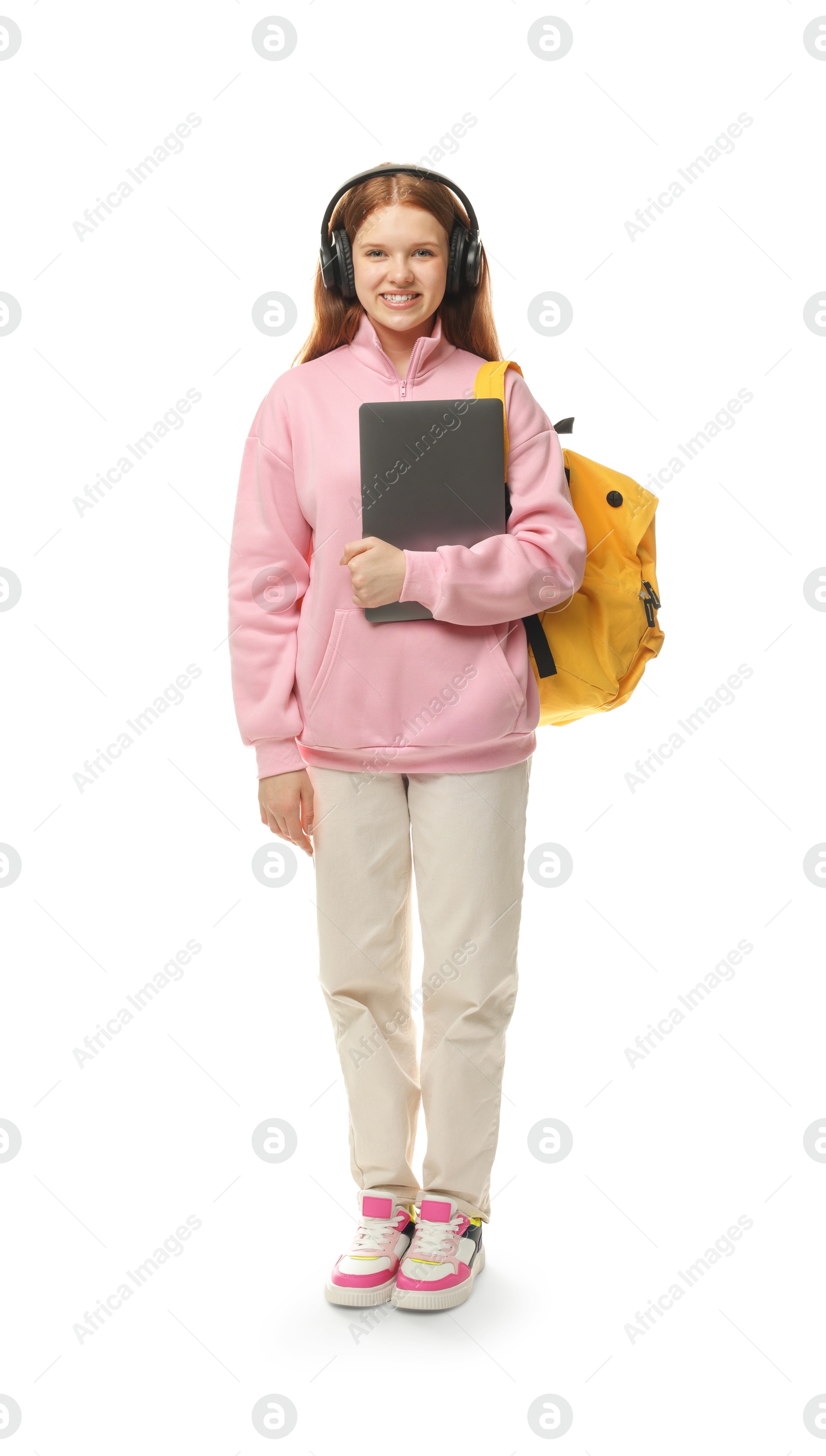 Photo of Teenage girl with laptop, headphones and backpack on white background