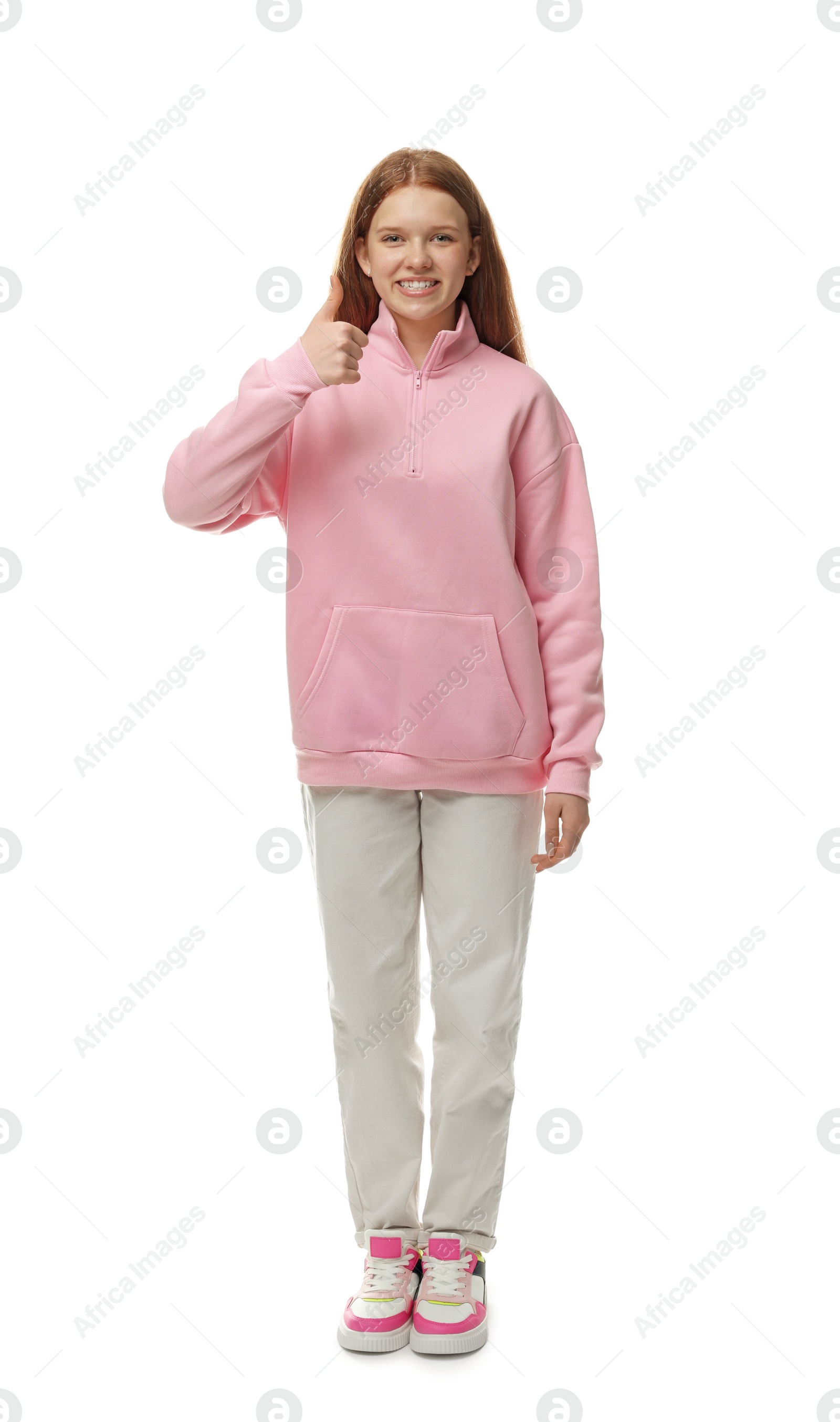 Teenage girl showing thumbs up on white background Photo of Teenage girl showing thumbs up on white background