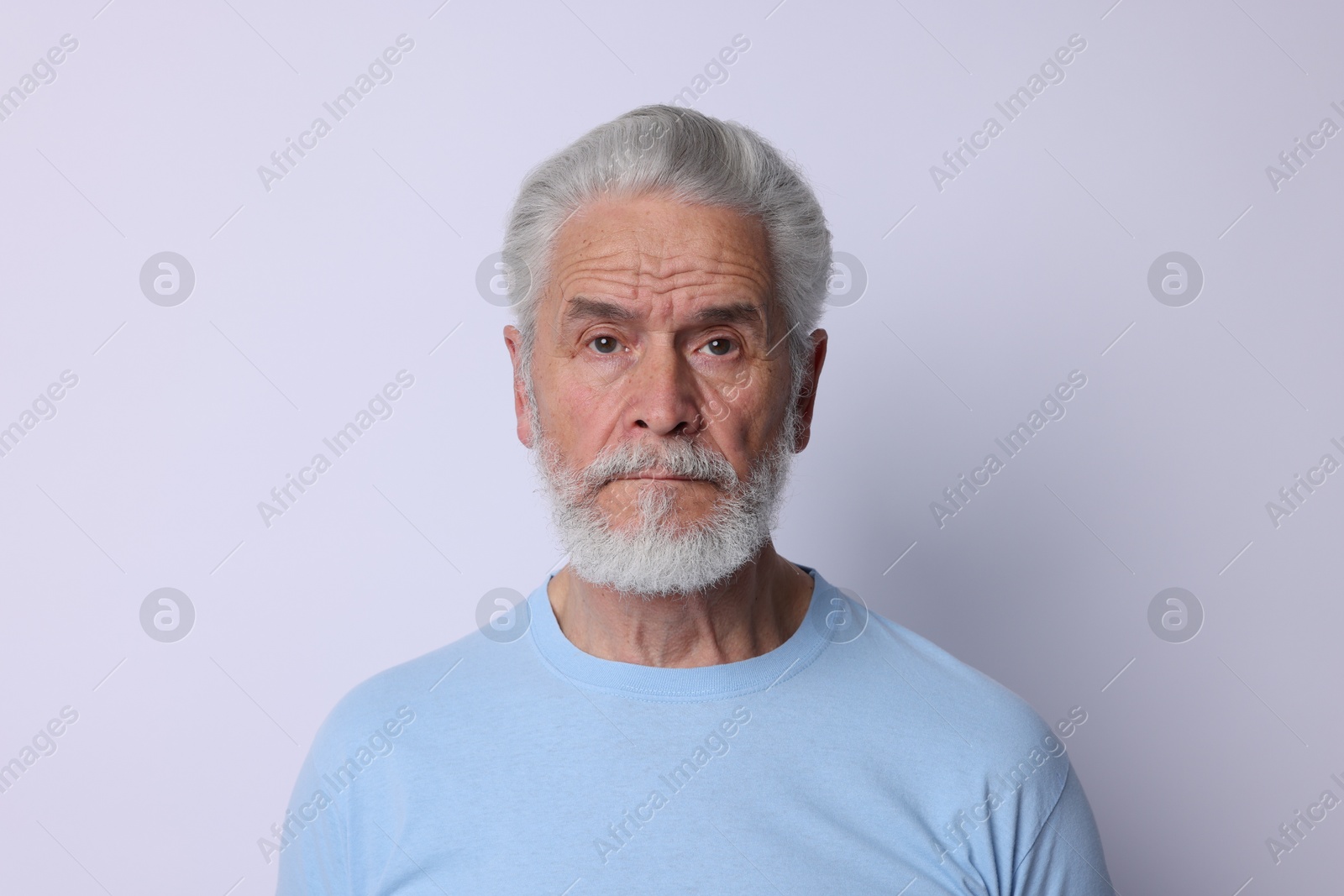Photo of Portrait of senior man on light background