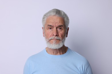 Photo of Portrait of senior man on light background