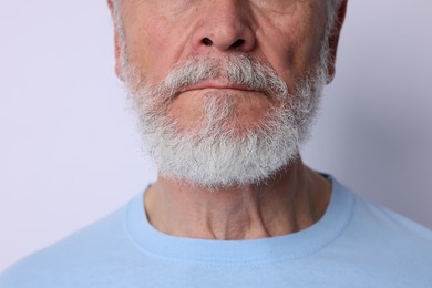 Photo of Man with silver beard on light background, closeup