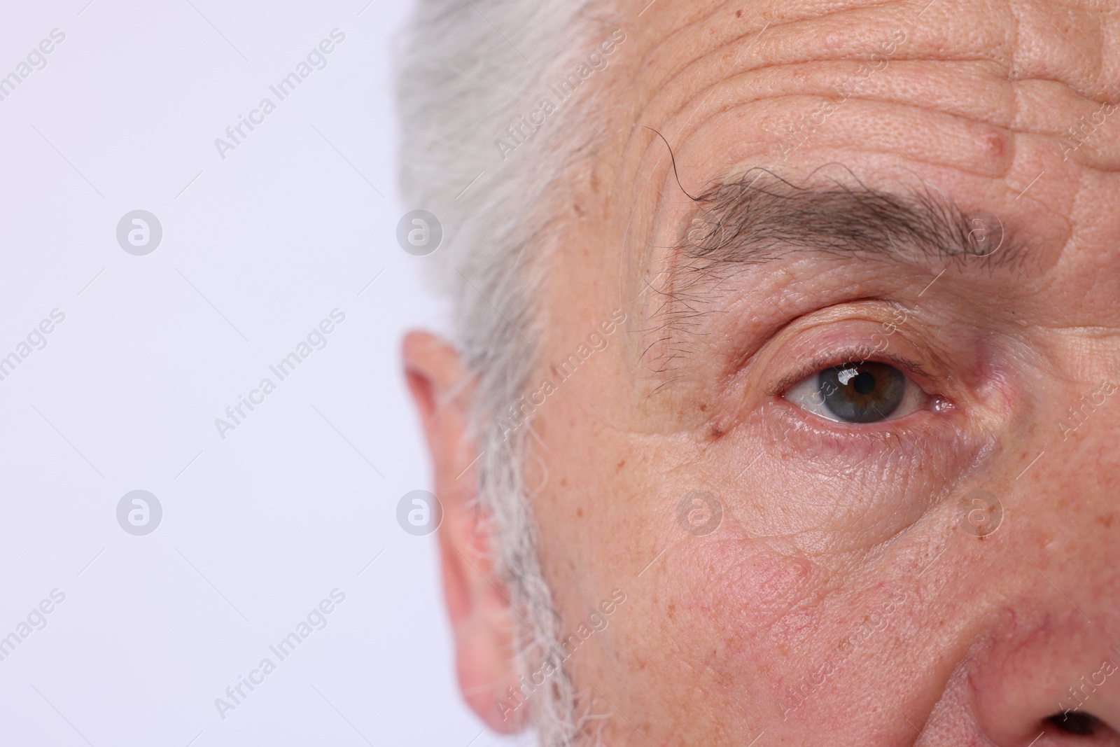 Confident senior man on light background, closeup Photo of Confident senior man on light background, closeup