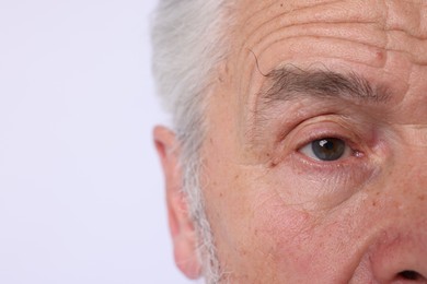 Photo of Confident senior man on light background, closeup