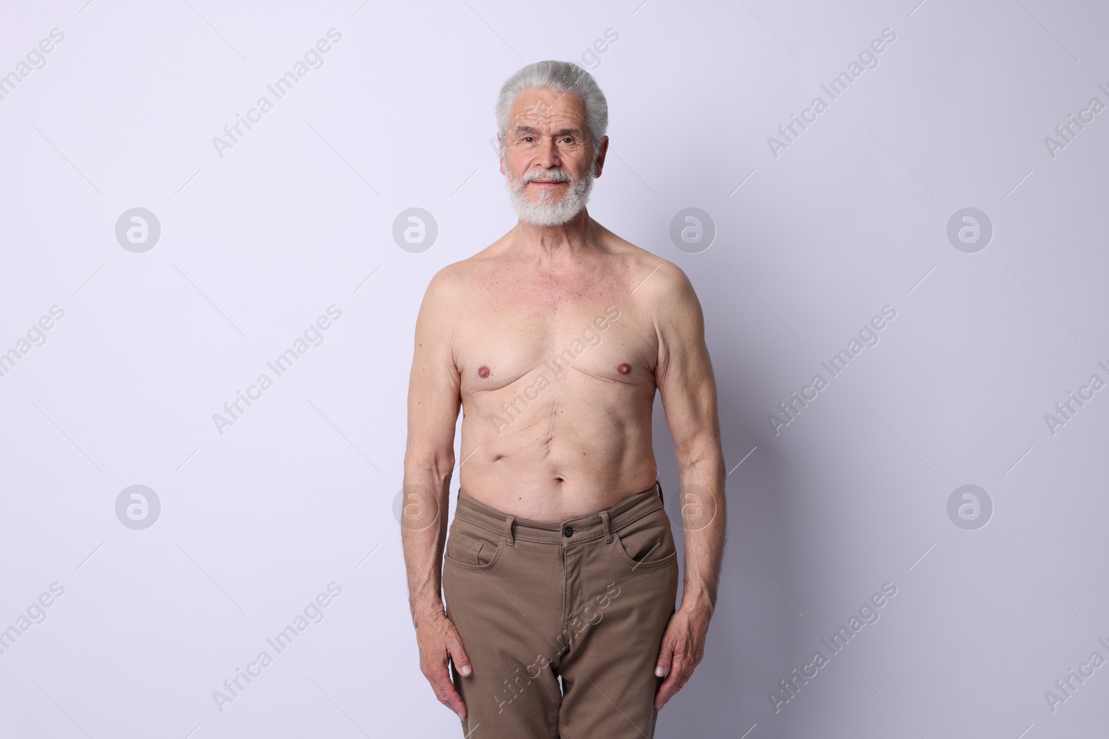 Photo of Portrait of confident senior man on light background