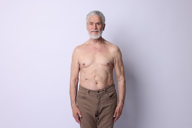 Photo of Portrait of confident senior man on light background