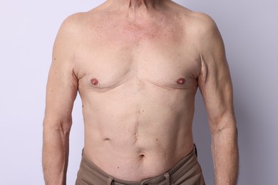 Photo of Shirtless senior man on light background, closeup