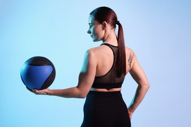 Photo of Woman with medicine ball on color background