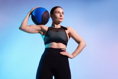 Photo of Woman with medicine ball on color background
