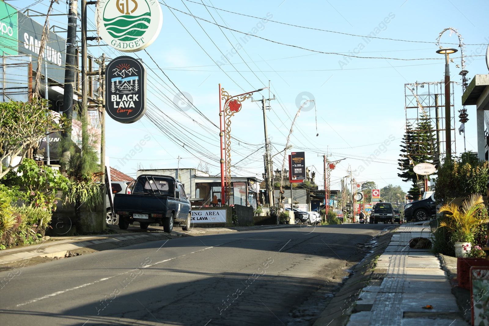 Bali, Indonesia - May 18, 2025: View of road with many cars and different shops Photo of Bali, Indonesia - May 18, 2025: View of road with many cars and different shops