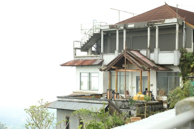 Photo of Bali, Indonesia - May 18, 2025: House with balcony and different plants