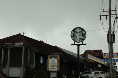 Photo of Bali, Indonesia - May 18, 2025: Starbucks coffee shop on city street