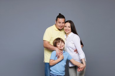 Photo of Portrait of happy family on grey background