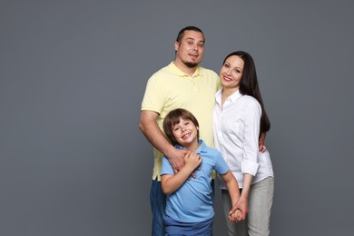 Photo of Portrait of happy family on grey background