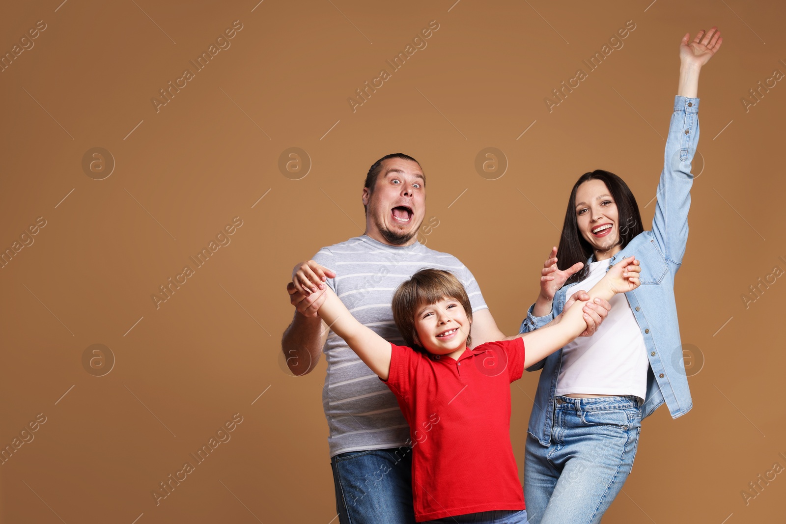 Portrait of happy family on brown background Photo of Portrait of happy family on brown background