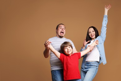 Photo of Portrait of happy family on brown background