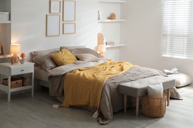 Photo of Comfortable bed with beautiful linens in bedroom