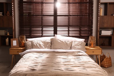 Photo of Comfortable bed with beautiful linens in bedroom