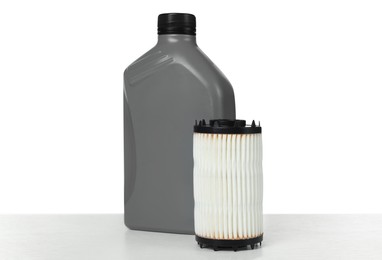 Photo of Motor oil in plastic bottle and filter isolated on white