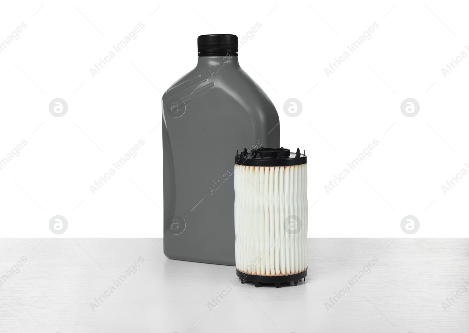 Motor oil in plastic bottle and filter isolated on white Photo of Motor oil in plastic bottle and filter isolated on white