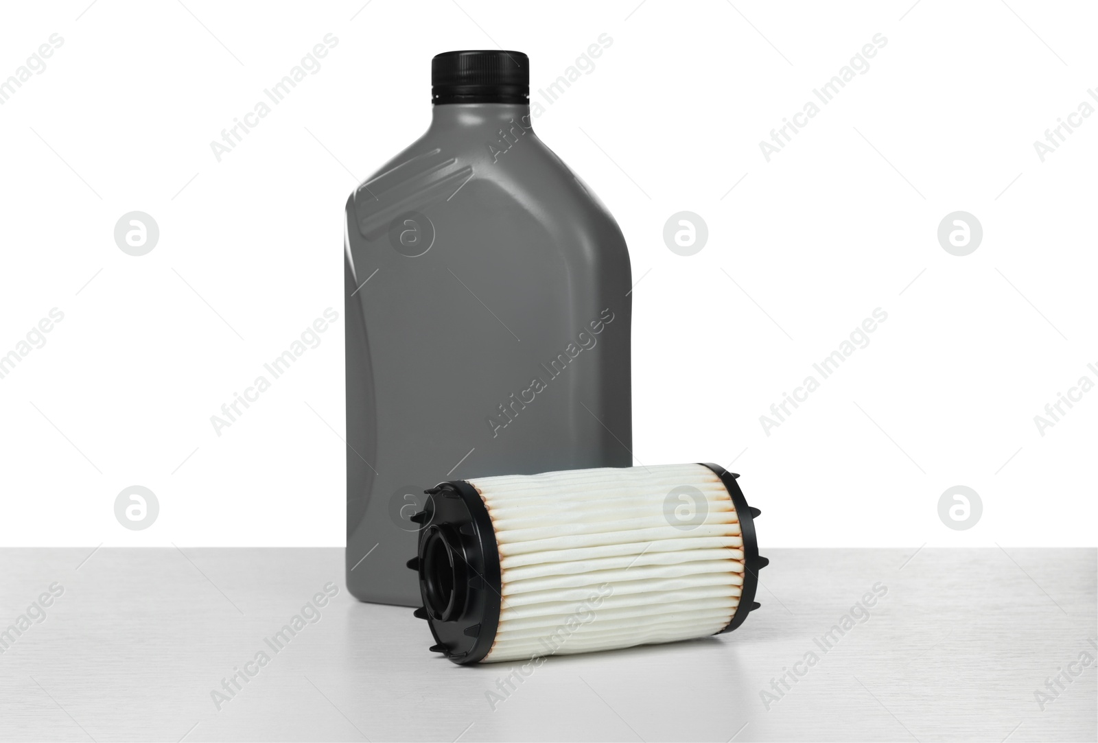 Photo of Motor oil in plastic bottle and filter isolated on white