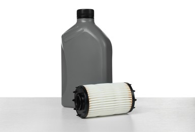 Photo of Motor oil in plastic bottle and filter isolated on white