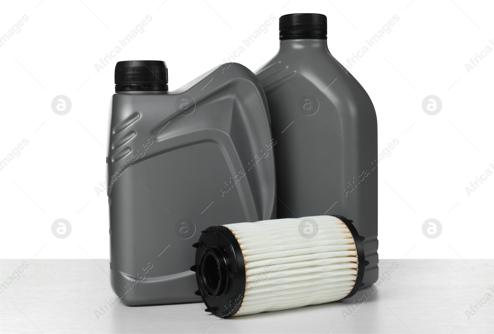Photo of Motor oil in plastic canisters and filter isolated on white