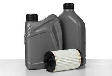 Photo of Motor oil in plastic canisters and filter isolated on white