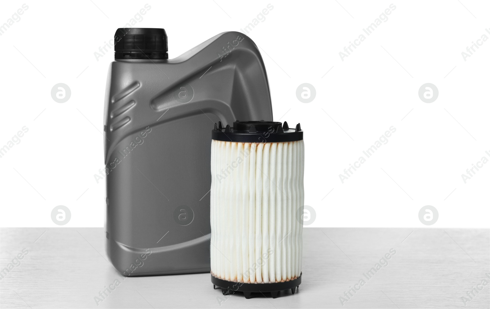 Photo of Motor oil in plastic canister and filter isolated on white