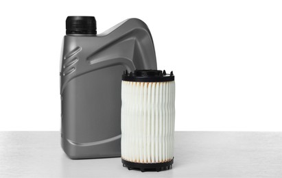Photo of Motor oil in plastic canister and filter isolated on white