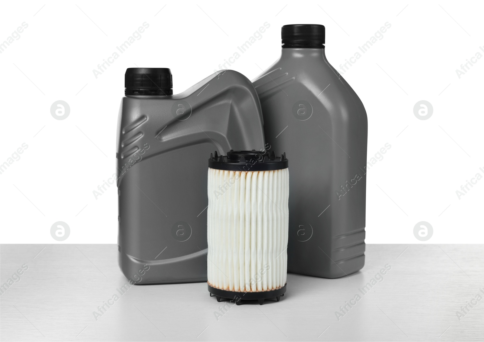 Photo of Motor oil in plastic canisters and filter isolated on white