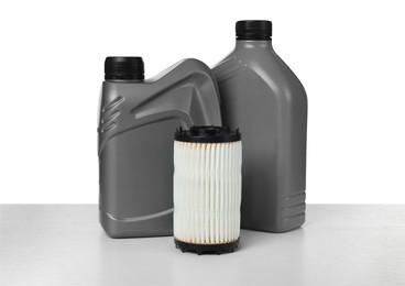 Photo of Motor oil in plastic canisters and filter isolated on white