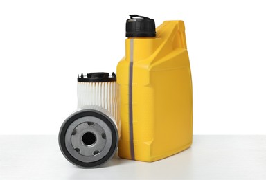 Photo of Motor oil in yellow canister and filters isolated on white